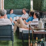 men sitting in backyard