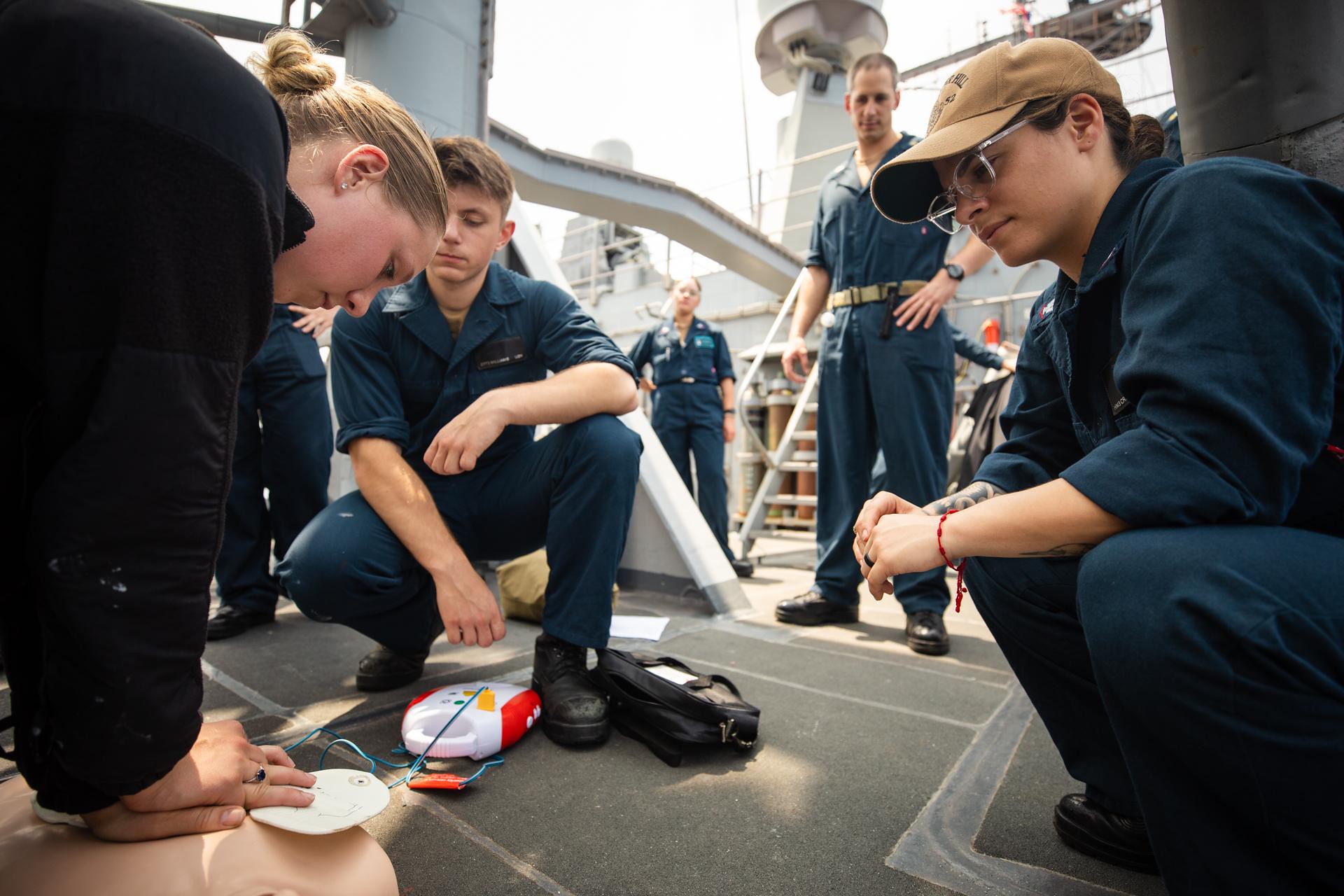 Beaver native performs chest compressions on a practice dummy aboard USS Bunker Hill