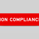 A red tab pops up out of a stark, white background. The red tab reads "non-compliance" in white letters.