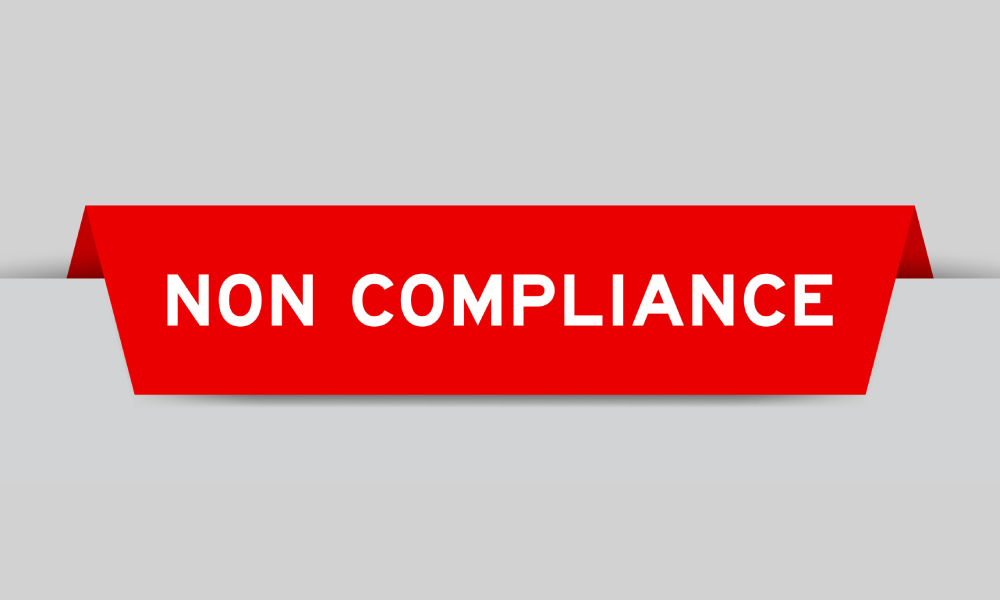 A red tab pops up out of a stark, white background. The red tab reads "non-compliance" in white letters.