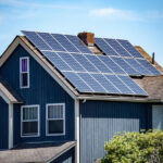 An American-style residential home with sustainable solar panels installed to the roof, soaking in solar energy from the sun.