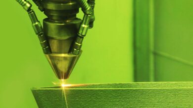 A close-up of a 3D printer using a method known as direct metal laser sintering to print a metal object.