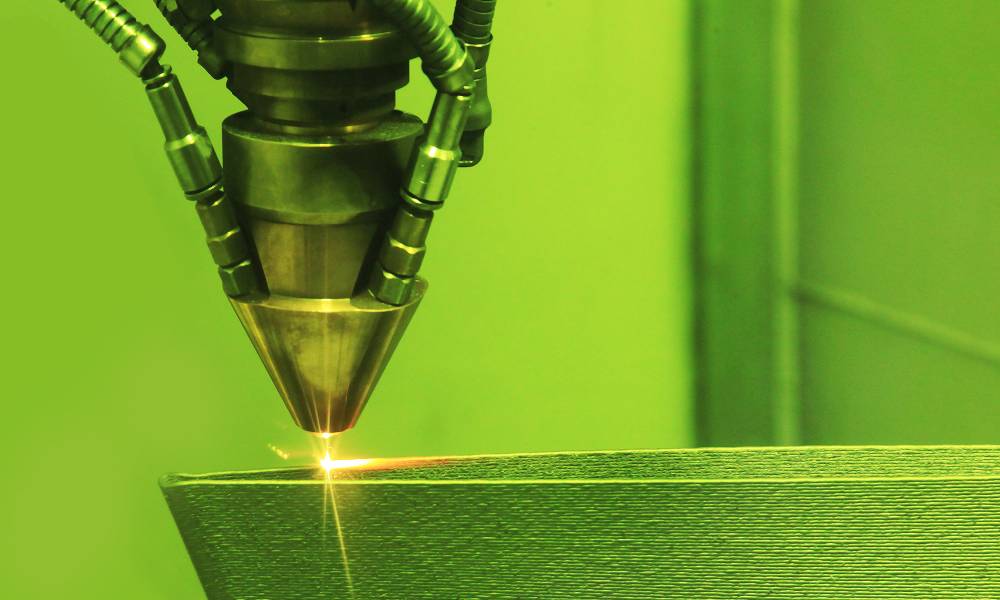 A close-up of a 3D printer using a method known as direct metal laser sintering to print a metal object.