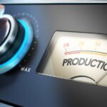 A hand turns a dial on a machine that is labeled "Work." Next to it, a needle moves on a meter labeled "Production"