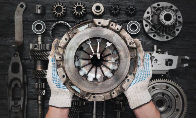 Close-up of a pair of hands holding up a used clutch basket. The person is wearing white and blue gloves on their hands.