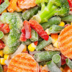 A medley of frozen vegetables includes carrots, broccoli, corn, green beans, red bell peppers, and cauliflower.