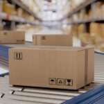 A close-up of a warehouse of cardboard boxes on conveyor belts, prepared for courier shipping and distribution.