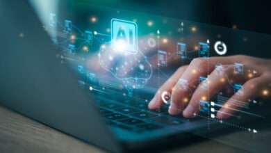 A person typing on a laptop keyboard with a glowing digital interface overlay showing an AI icon, brain graphic, and data nodes.