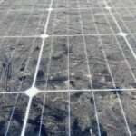 A large solar panel that is covered with dirt and dust, preventing it from absorbing as much sunlight.