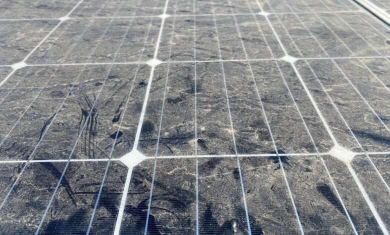 A large solar panel that is covered with dirt and dust, preventing it from absorbing as much sunlight.