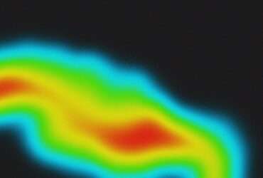 A black abstract background with neon gradient spots and noisy texture forming a heat map pattern in pink, orange, and blue.