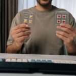 A man holds several mechanical keyboard switches while comparing parts for a custom mechanical keyboard project.