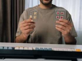A man holds several mechanical keyboard switches while comparing parts for a custom mechanical keyboard project.