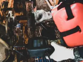 A worker inspects heavily corroded industrial pipes. An ultrasonic tool tests the remaining metal thickness.