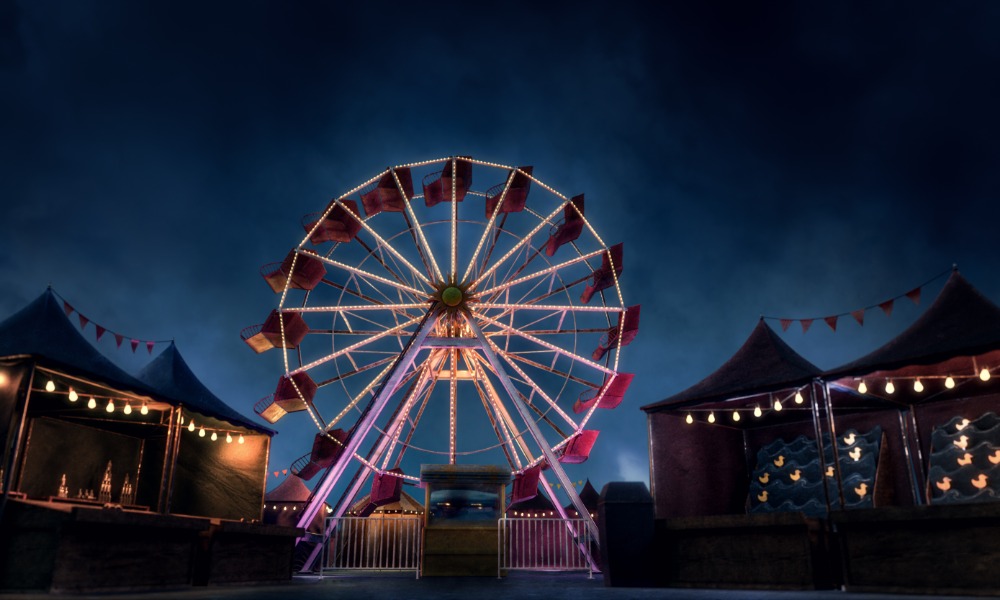 A massive brightly lit ferris wheel in the middle of a carnival at nighttime. The carnival is empty.
